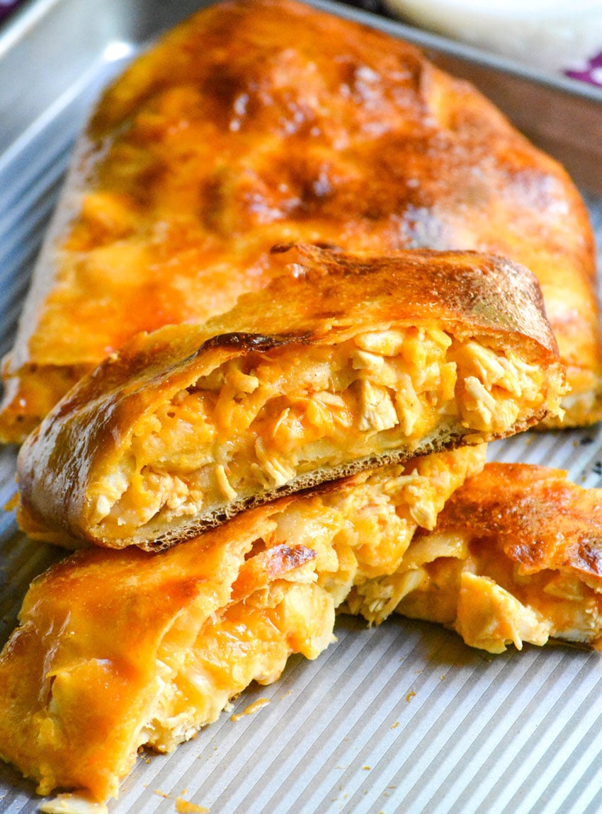 slices of buffalo chicken garbage bread on a metal baking sheet