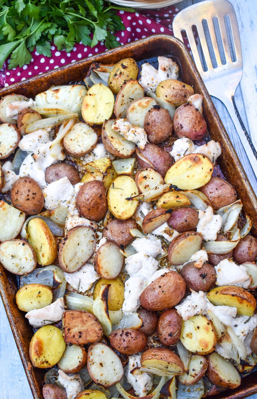 roasted chicken and vegetables on a metal sheet pan