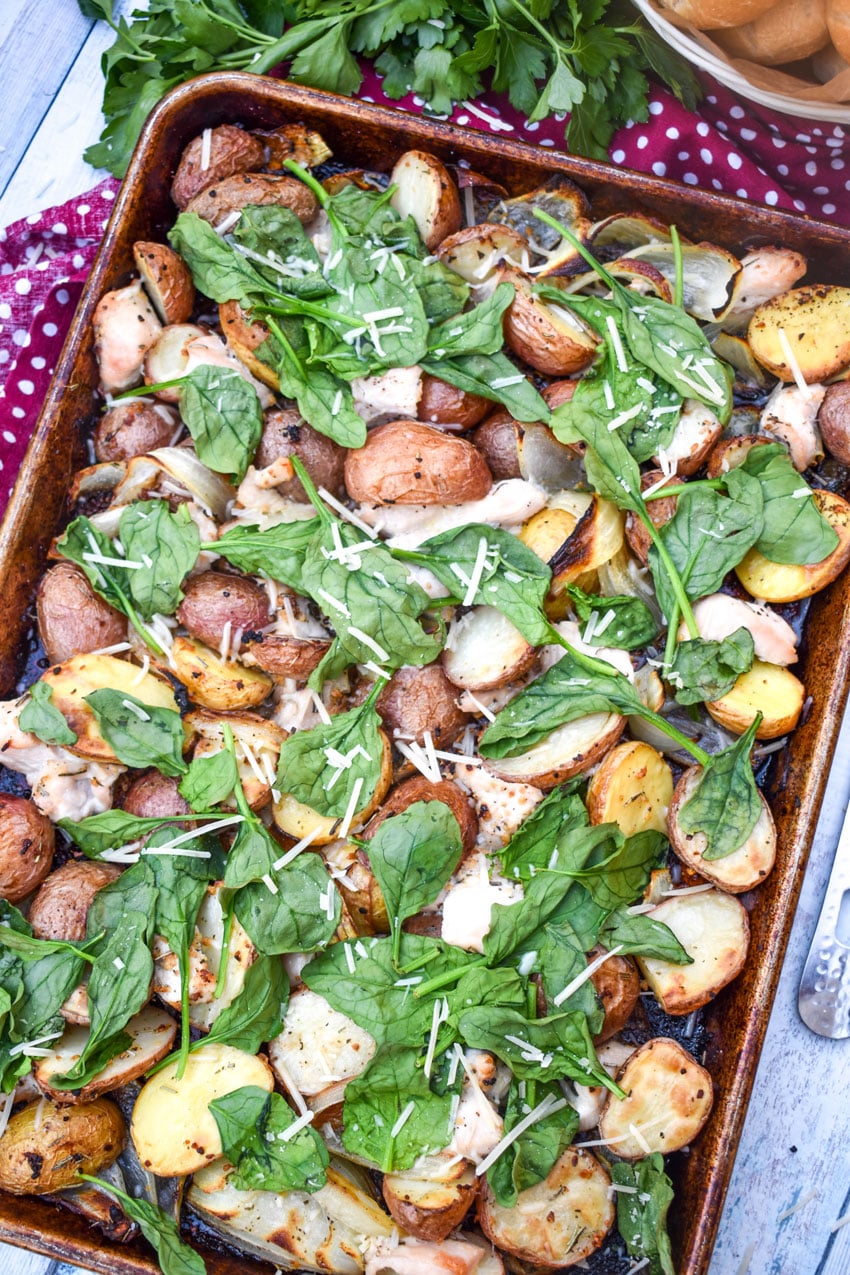 roasted chicken and vegetable dinner on a metal sheet pan