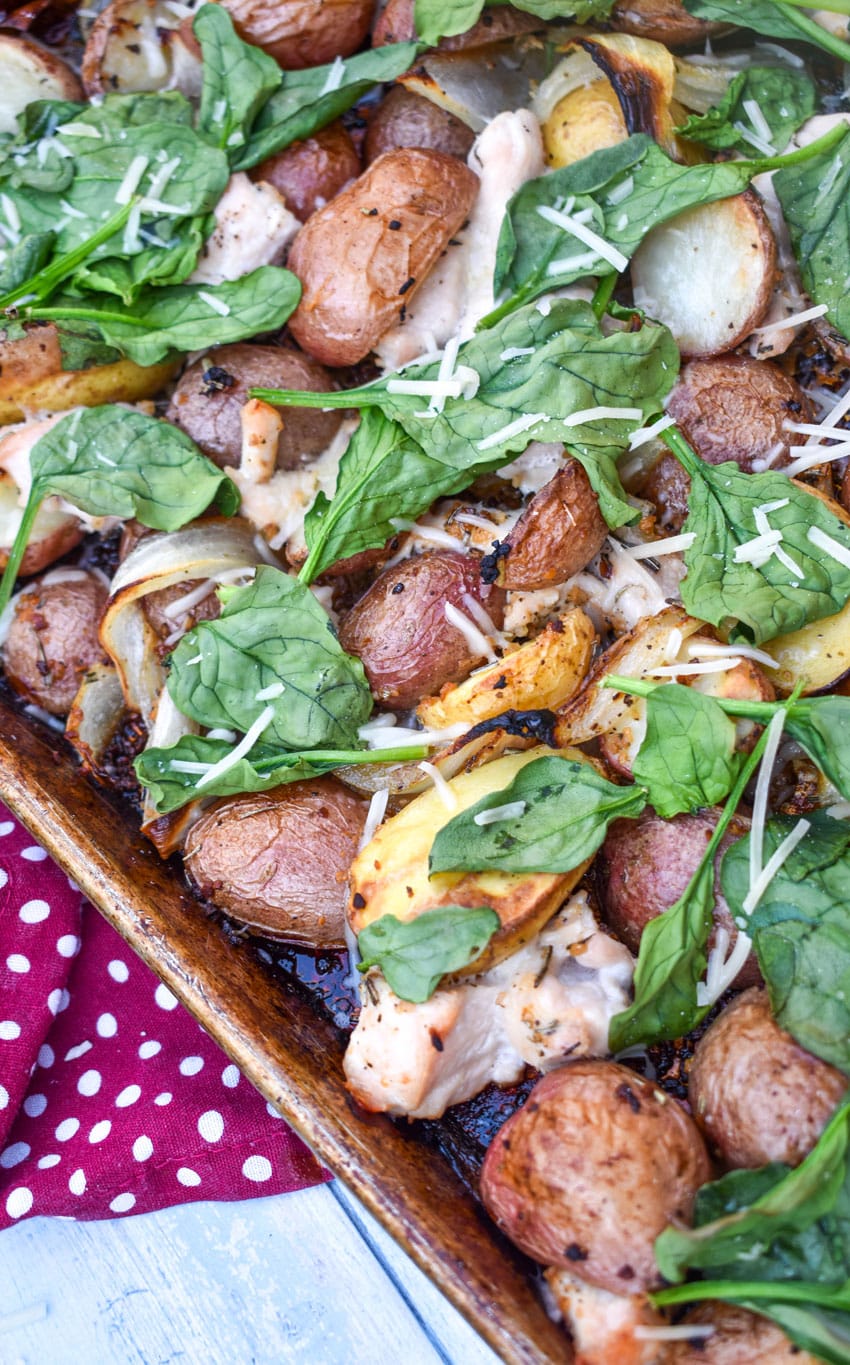 roasted chicken and vegetable dinner on a metal sheet pan