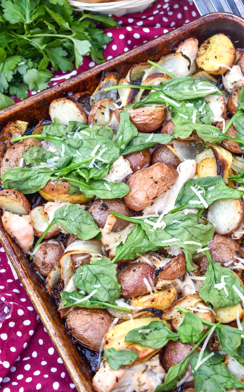 roasted chicken and vegetable dinner on a metal sheet pan