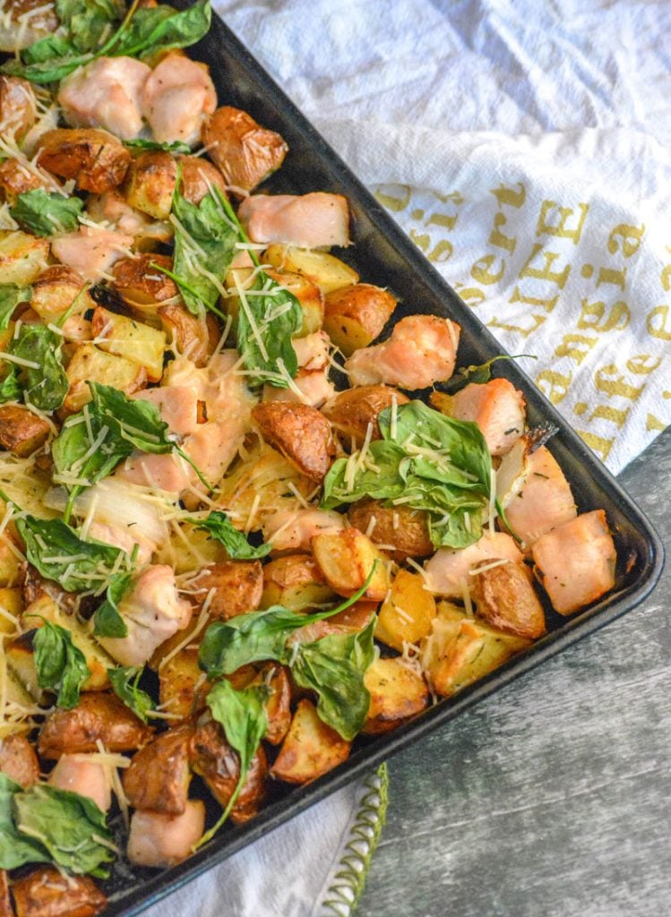 Roasted Chicken and Vegetable Sheet Pan Supper on a gray background with the sheet pan set on a white dish towel with yellow lettering