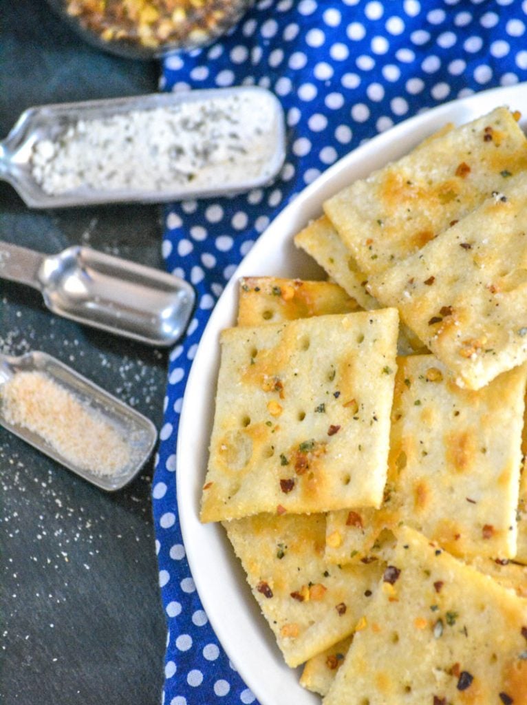 Alabama Fire Crackers in a white bowl on a white polka dotted blue cloth background with various spices