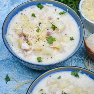 chicken cordon bleu soup in two blue bowls