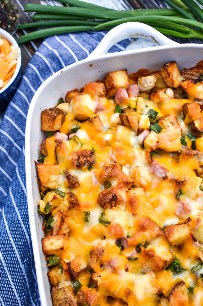loaded baked potato chicken casserole in a white baking dish