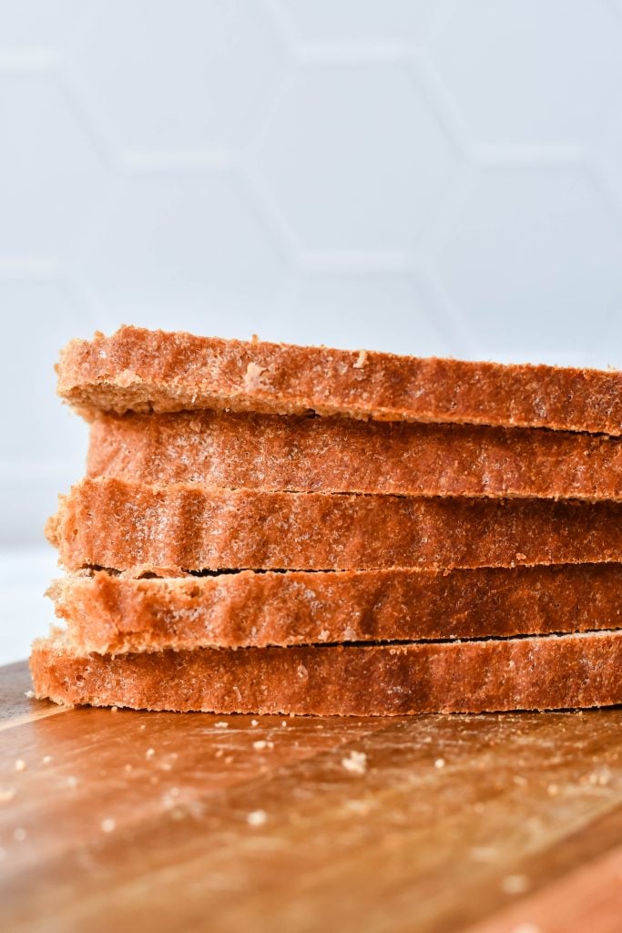 a stack of sliced honey wheat sandwich bread