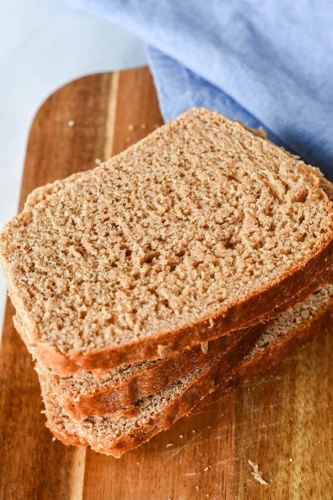 a stack of fresh sliced honey wheat sandwich bread