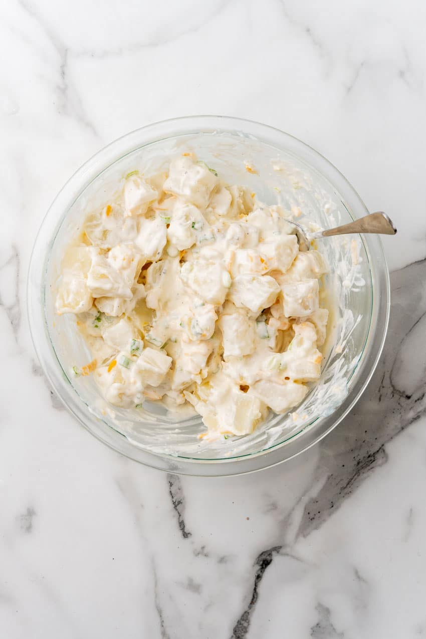 loaded baked potato salad in a glass mixing bowl