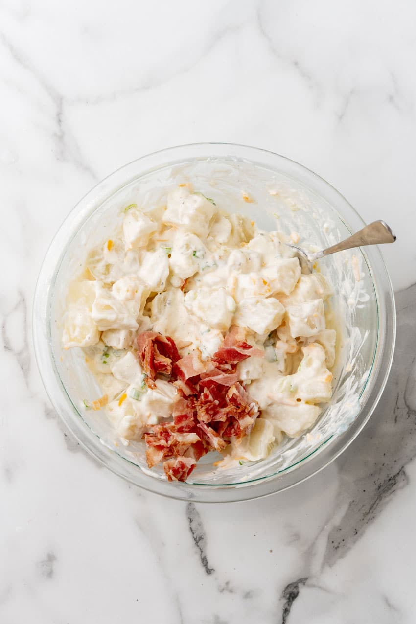 loaded baked potato salad in a glass mixing bowl