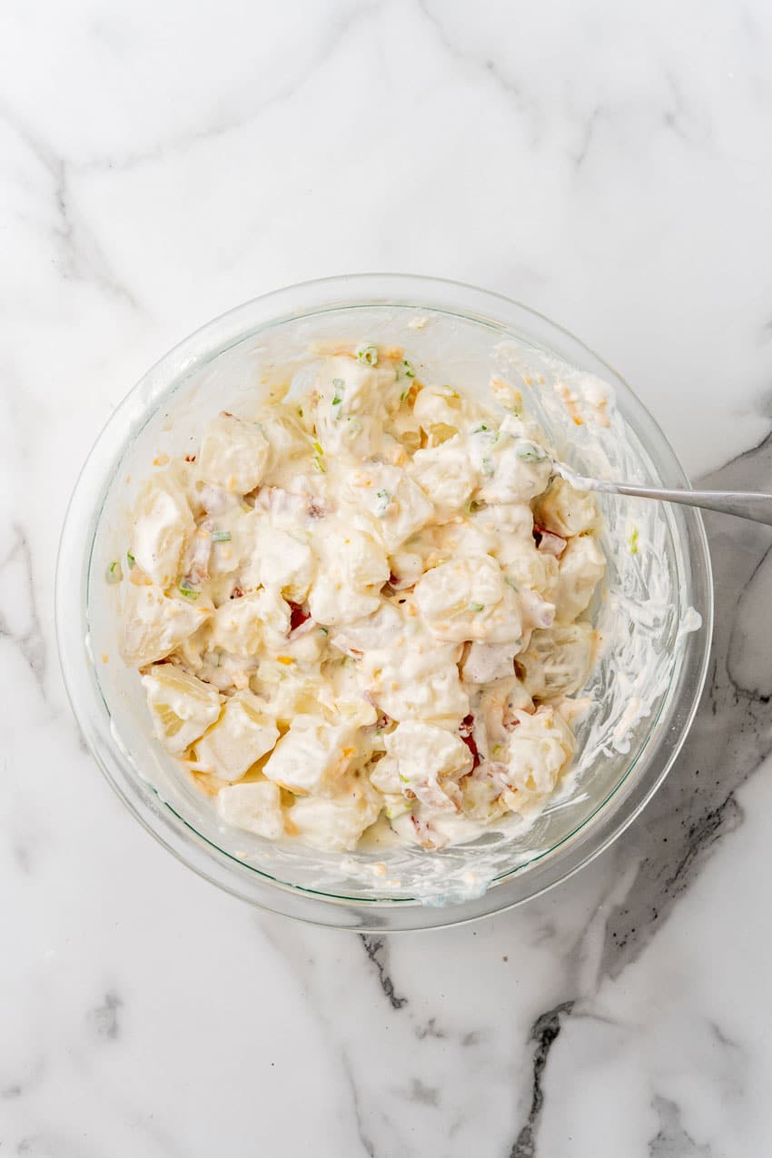 loaded baked potato salad in a glass mixing bowl