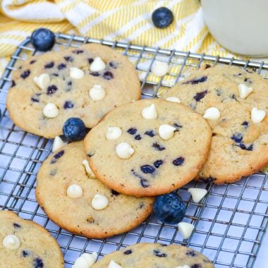 blueberry cheesecake cookies with white chocolate chips on a metal cooling rack