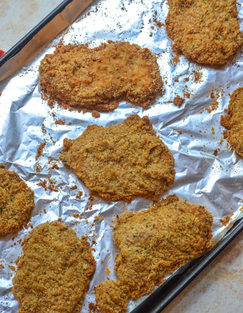 Crispy, Baked Italian Ranch Pork Chops on a foil lined baking sheet