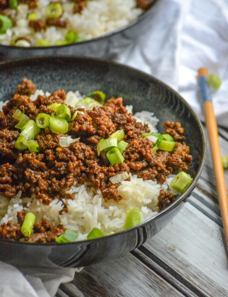 Korean Beef Bulgogi in a blue and black bowl on a wooden background