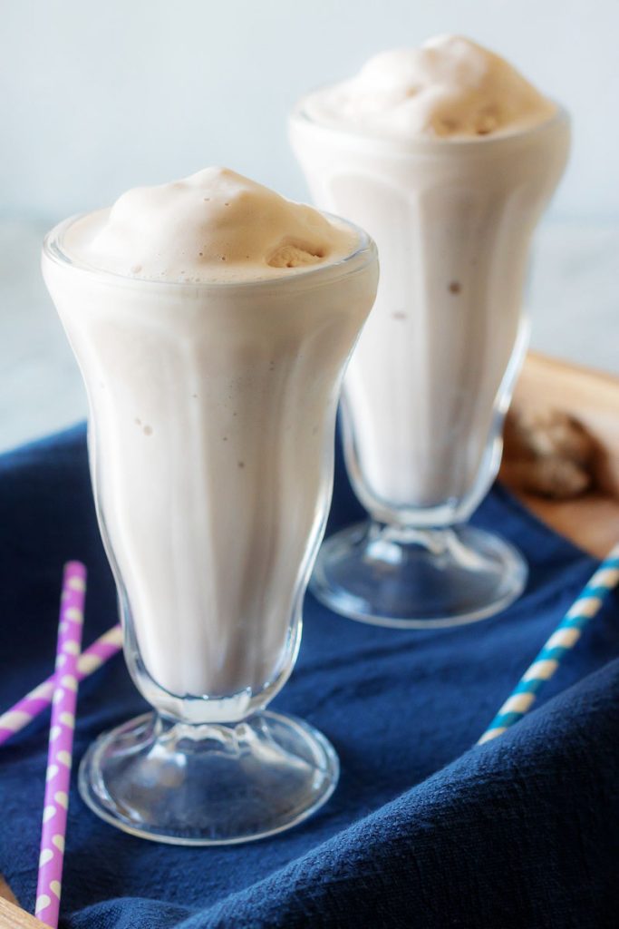 Copy Cat Wendy's Frosty in two high milkshake glasses in a wooden serving tray with a dark blue cloth napkin