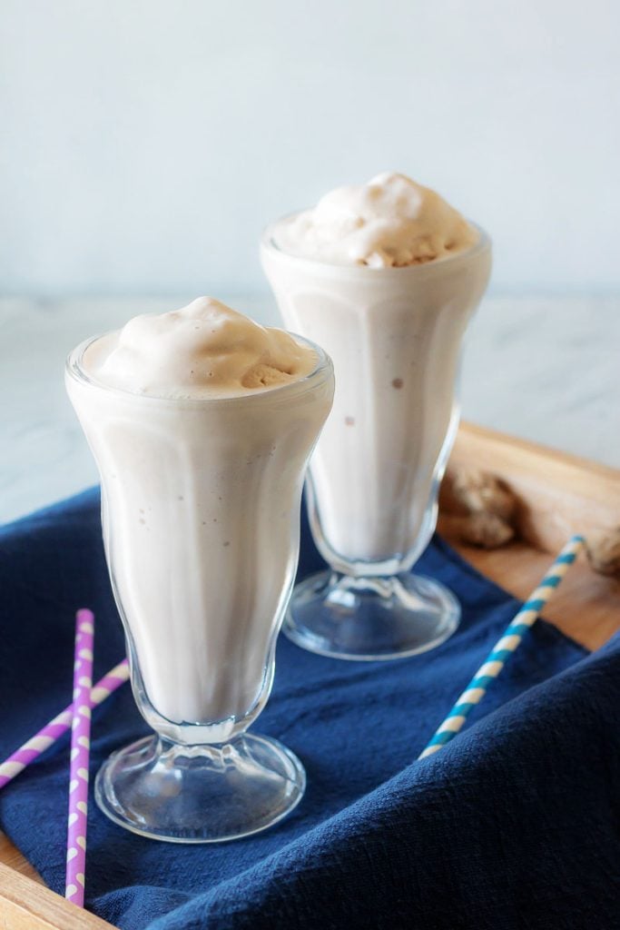 Copy Cat Wendy's Frosty in two high milkshake glasses in a wooden serving tray with a dark blue cloth napkin