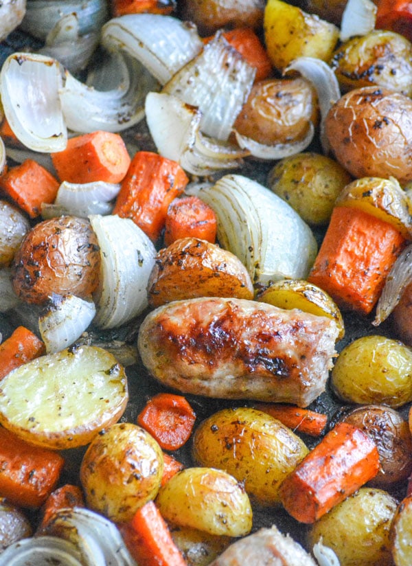 Italian Sausage Potato & Balsamic Vegetable Casserole also shown with carrots in a black roasting pan