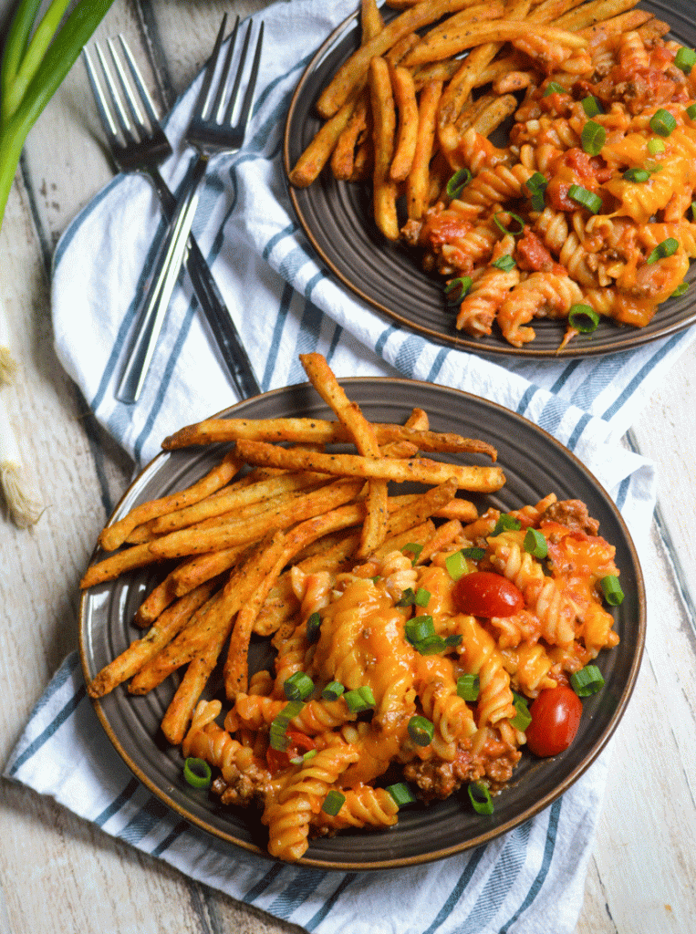 one pot cheeseburger pasta served with french fries on brown plates