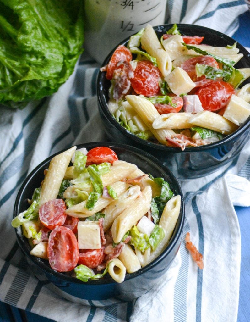 ranch blt pasta salad shown served in two small black bowls