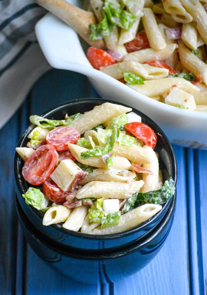 ranch blt pasta salad shown served in a small black bowl