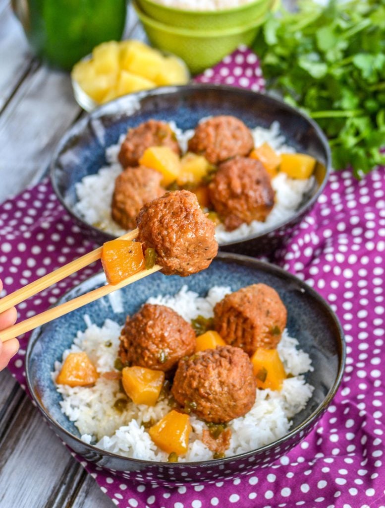 Crockpot Hawaiian Meatballs- meatballs glazed in a sweet & savory pineapple sauce with chunks of caramelized pineapple and tender green peppers over a bed of white rice