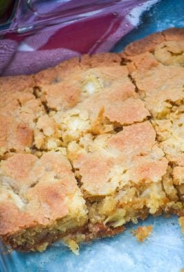 caramel apple blondies shown sliced into bars in a glass baking dish