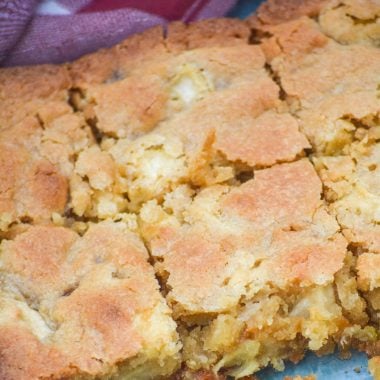 caramel apple blondies shown sliced into bars in a glass baking dish