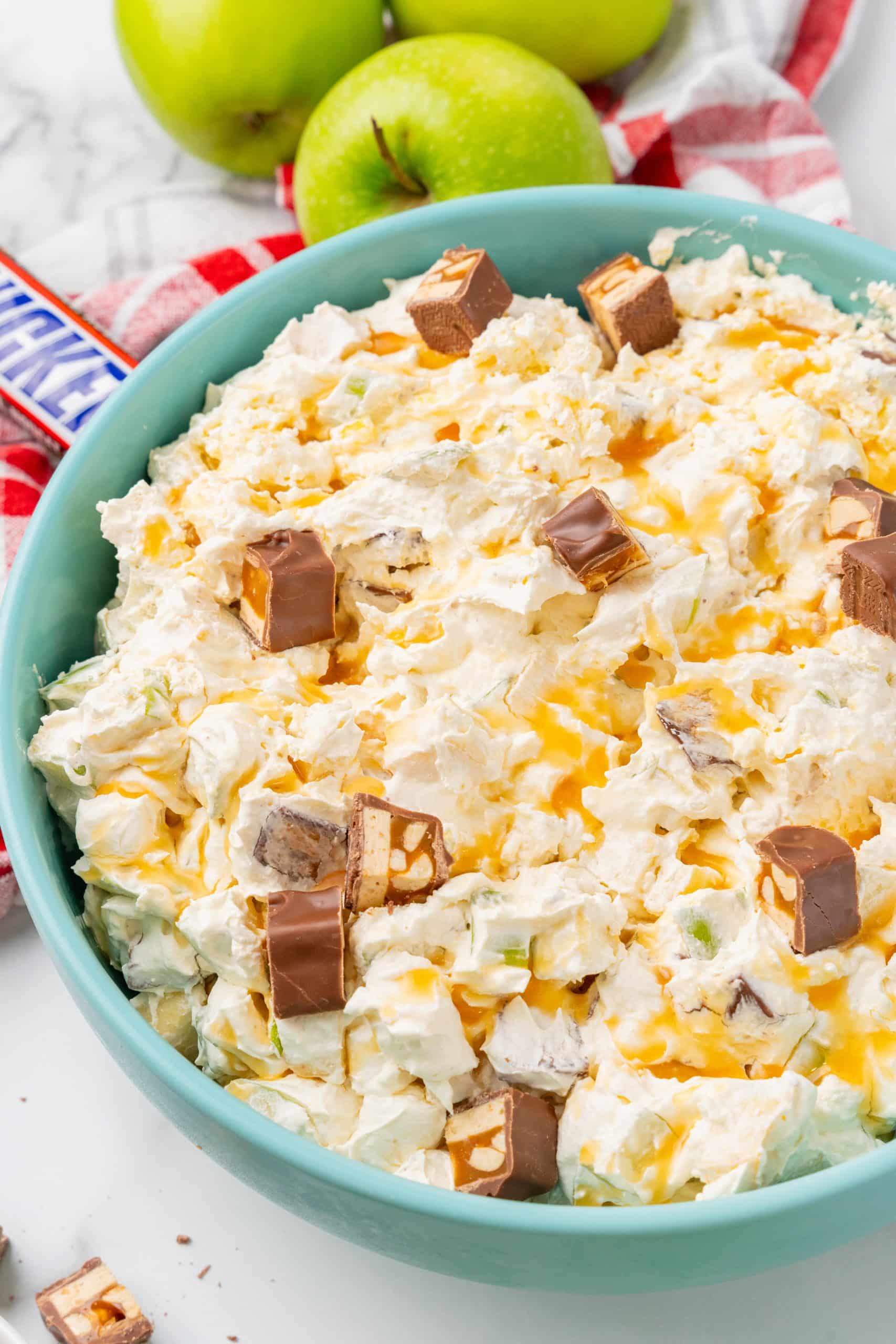 caramel apple snickers salad in a blue serving bowl