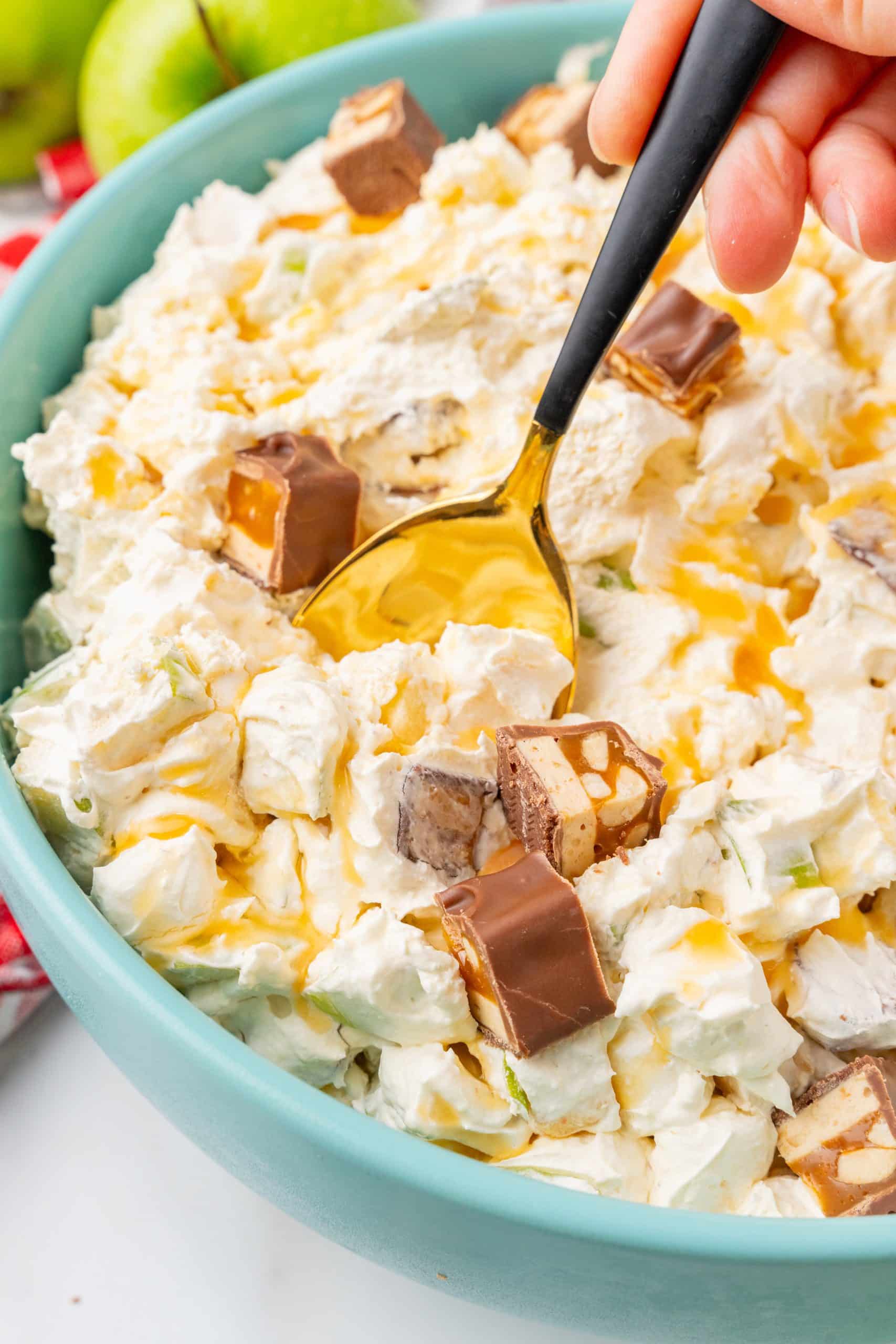 caramel apple snickers salad in a blue serving bowl