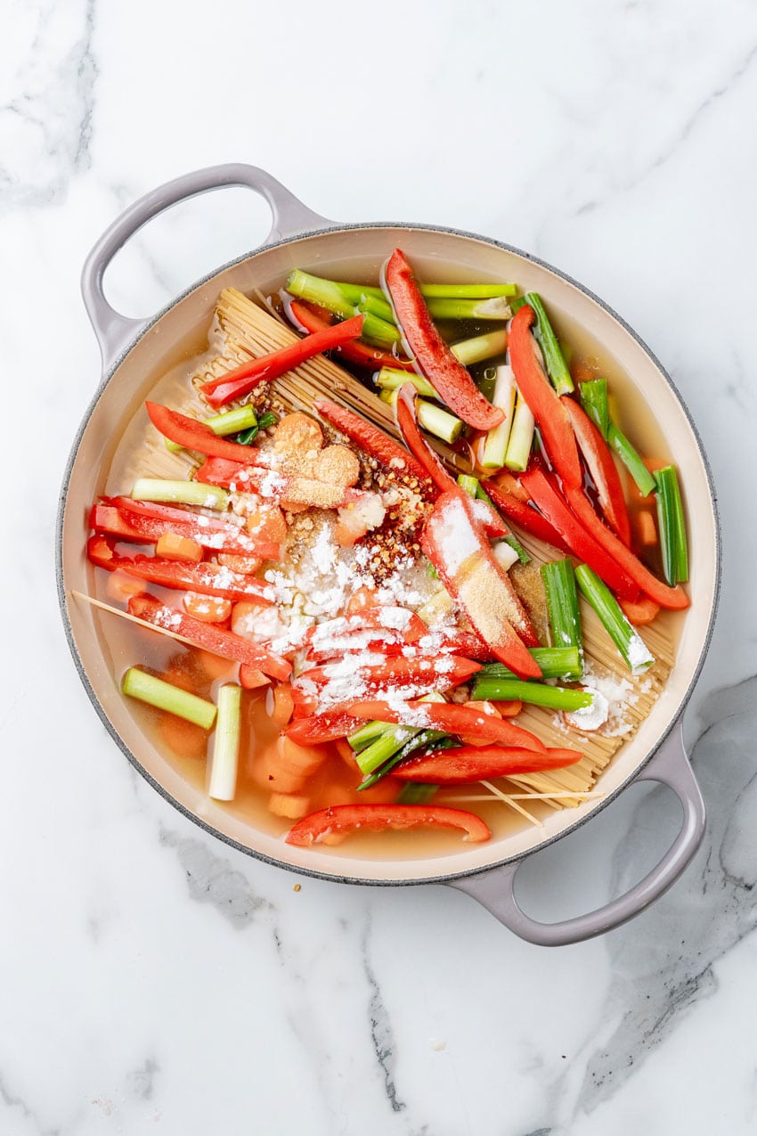 one pot chicken lo mein ingredients in a large cast iron skillet