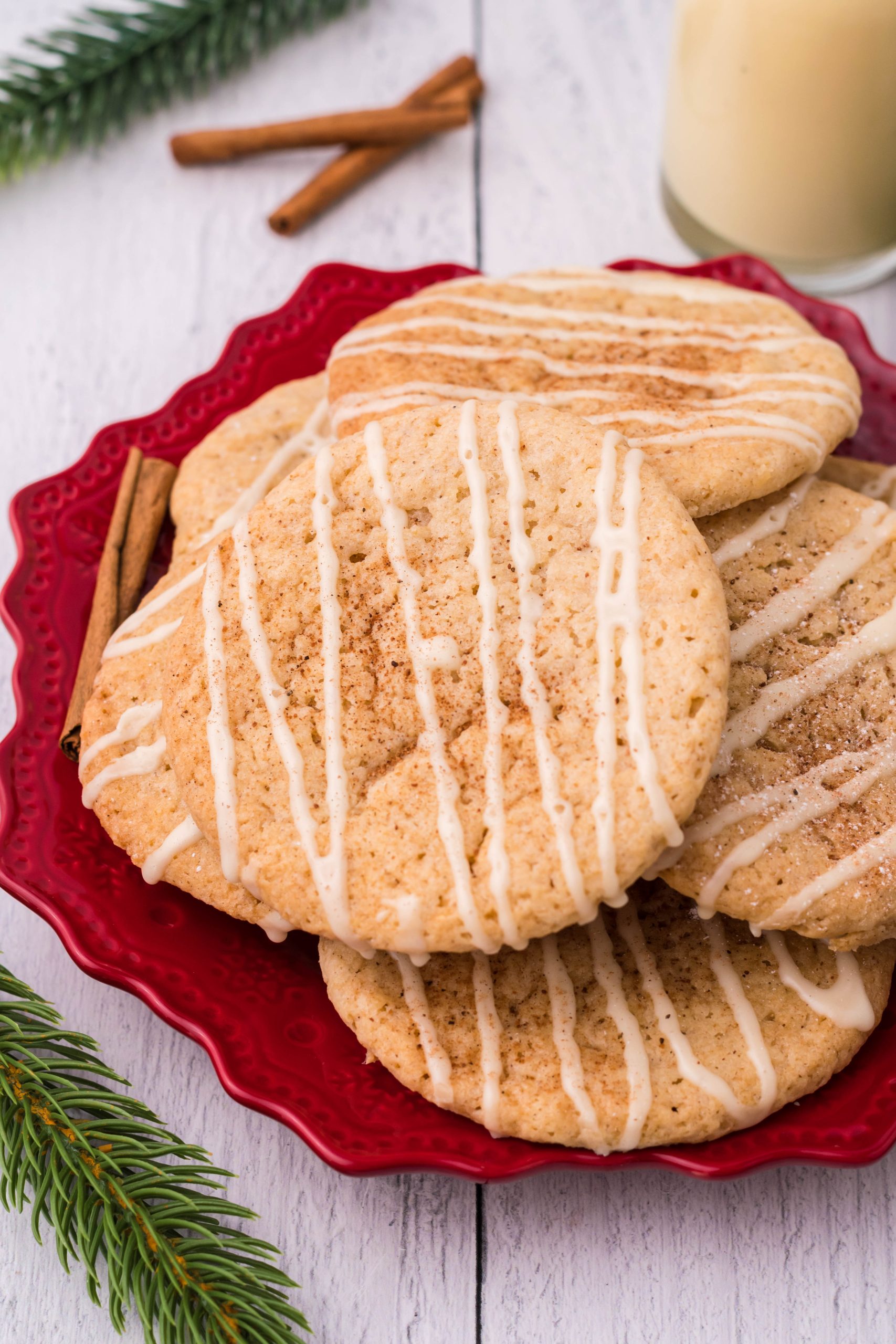 glazed eggnog cookies piled on a red plate