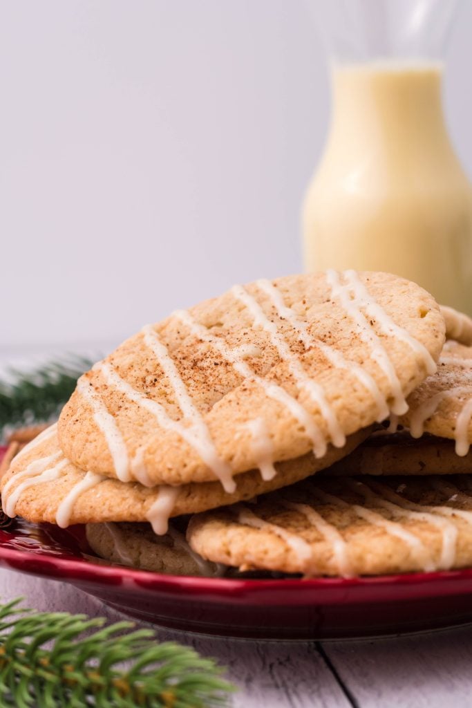 glazed eggnog cookies piled on a red plate