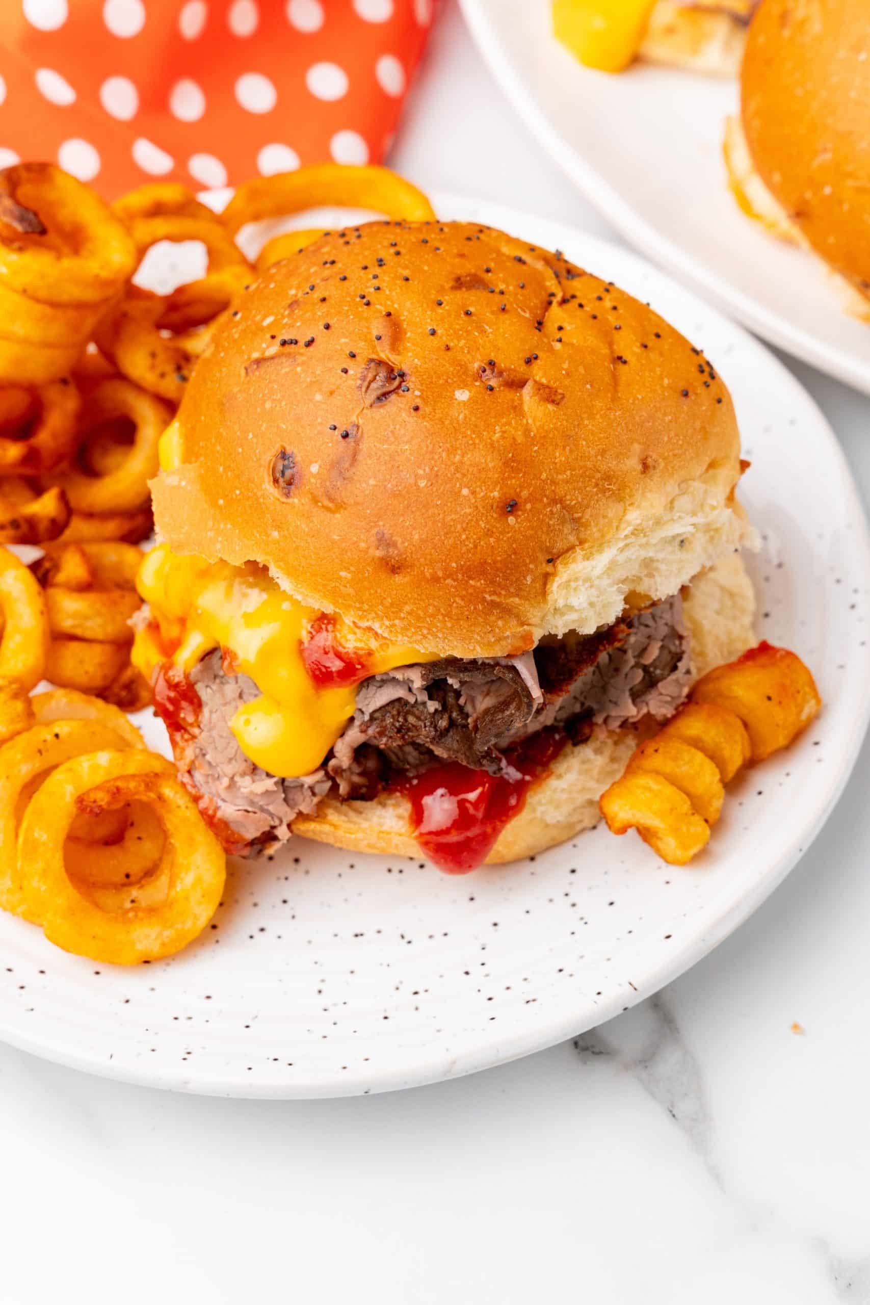 copycat arby's beef n' cheddars on white plates with curly fries on the side