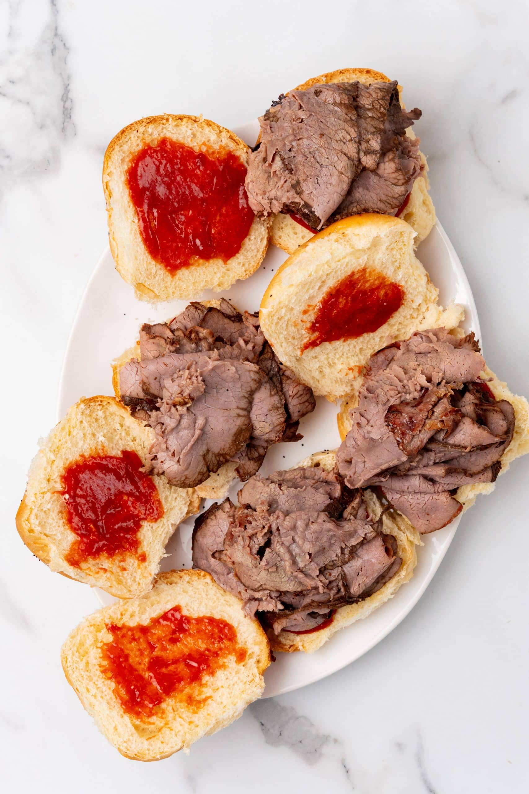 homemade arby's roast beef sandwiches on a white serving platter