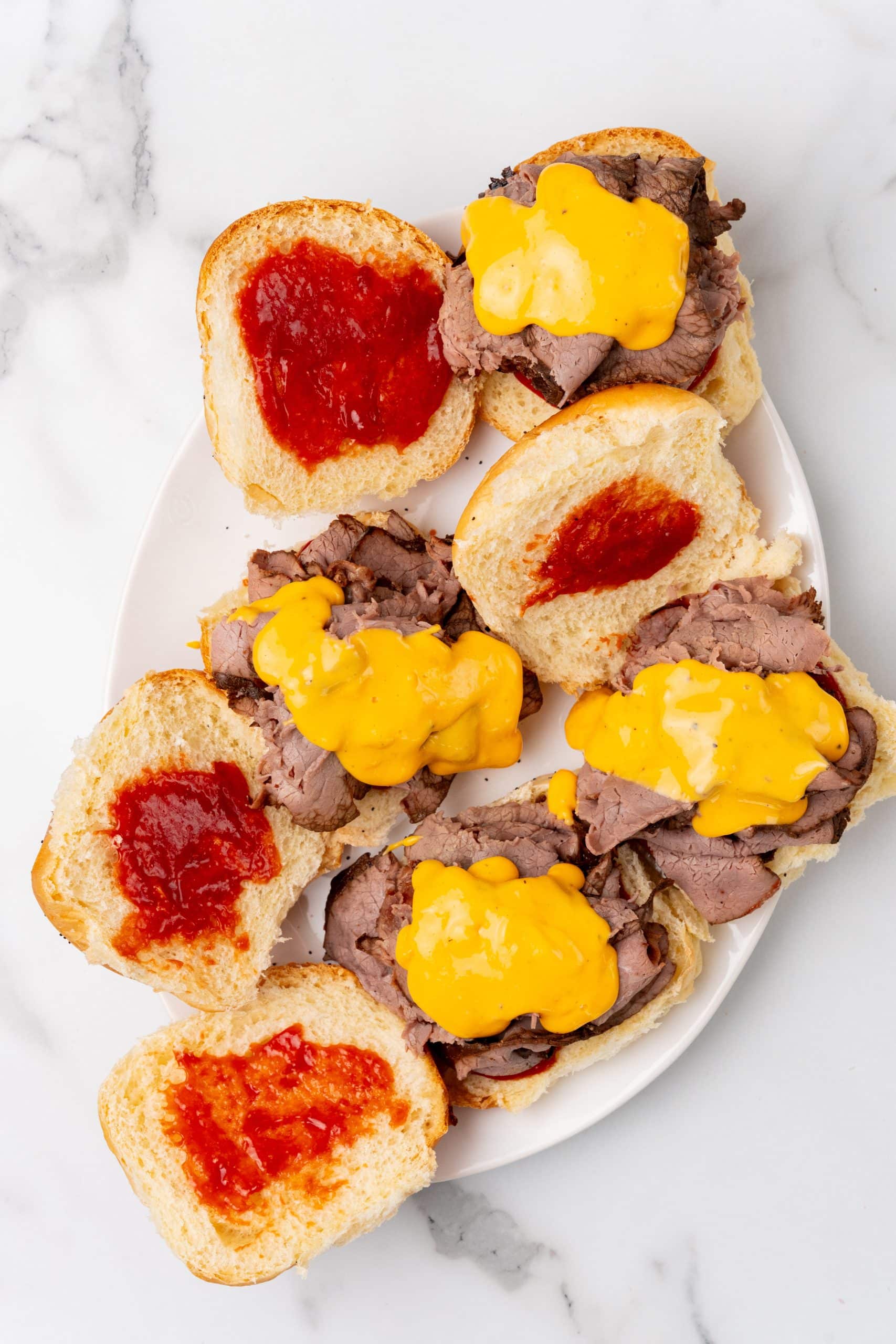 copycat arby's beef n' cheddar sandwiches on a white serving platter