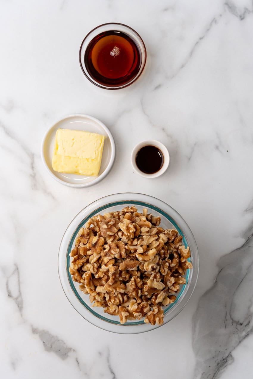 an overhead image showing the measured ingredients needed to make a batch of slow cooker maple walnuts