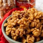 slow cooker maple walnuts in a small gray bowl