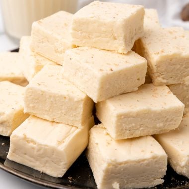 easy eggnog fudge stacked on a brown plate