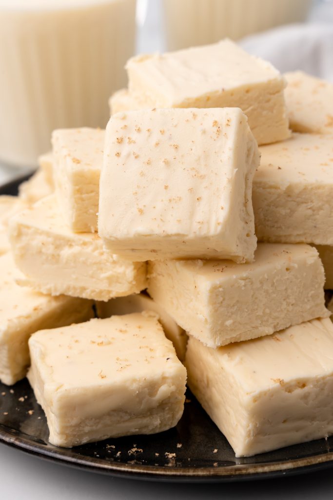 easy eggnog fudge stacked on a brown plate