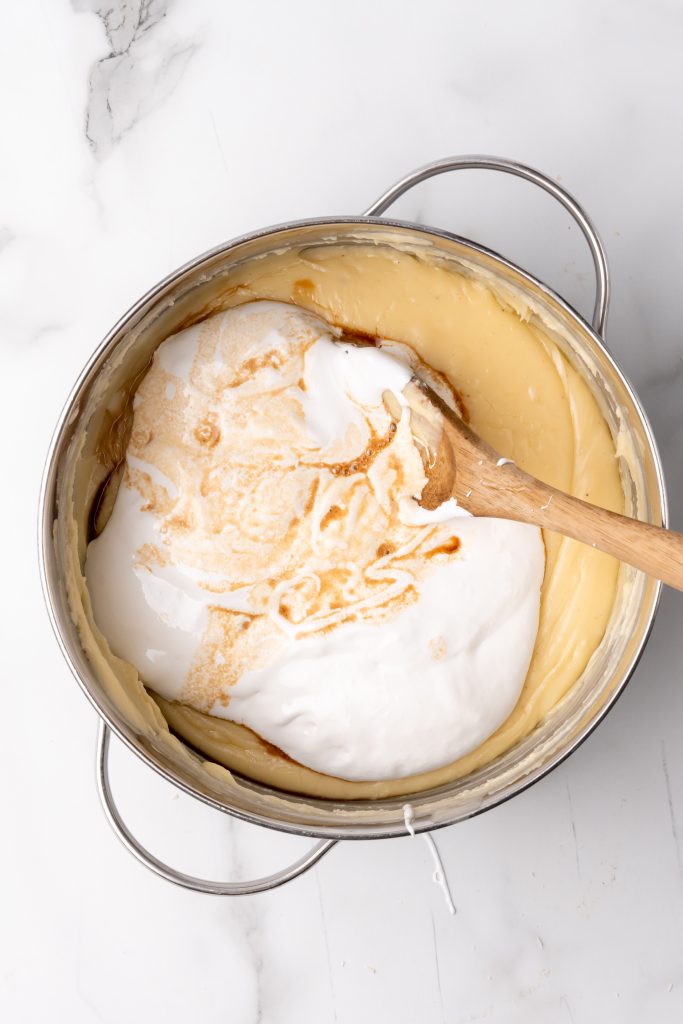 marshmallow creme in a skillet of eggnog fudge batter
