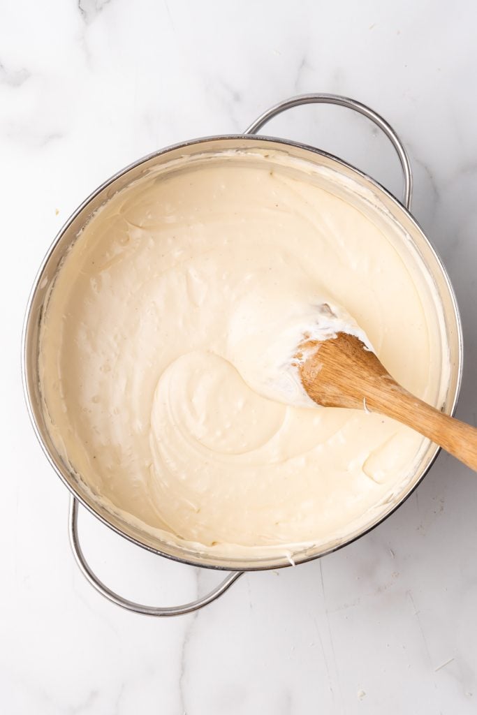 easy eggnog fudge batter in a skillet with a wooden spoon