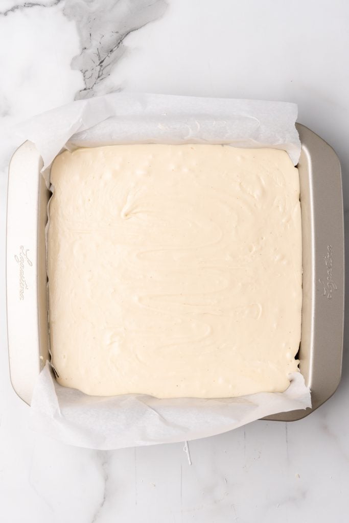 easy eggnog fudge batter in a parchment paper lined baking dish
