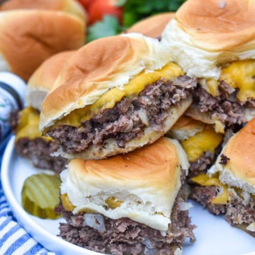 easy cheeseburger sliders stacked on a white plate