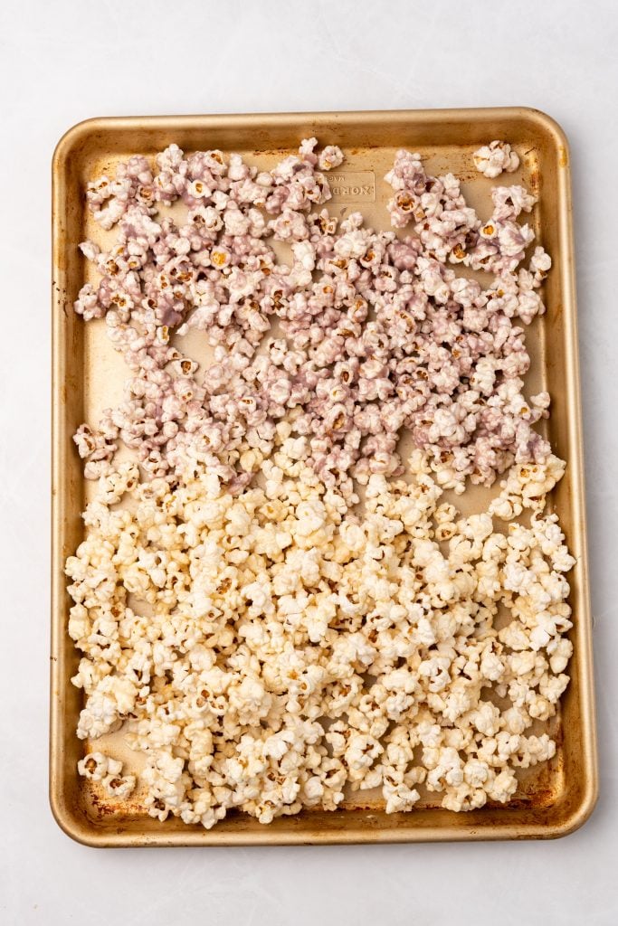 peanut butter and jelly flavored popcorn on a metal baking sheet
