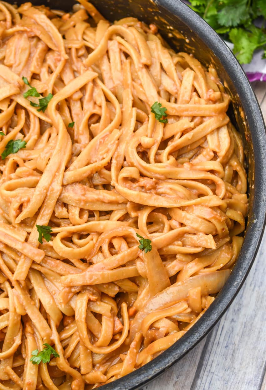 chinese peanut butter noodles in a large black skillet
