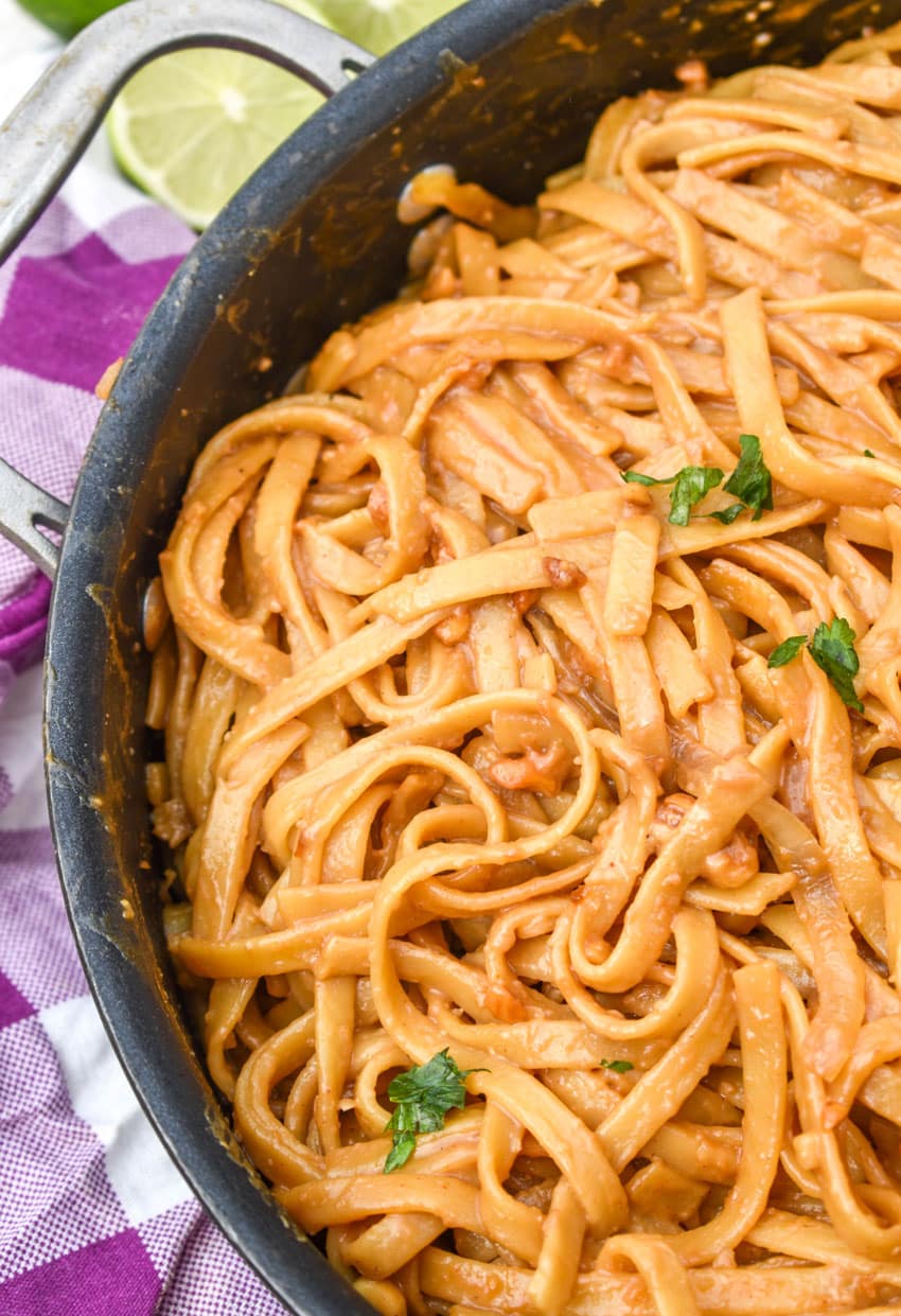 chinese peanut butter noodles in a large black skillet