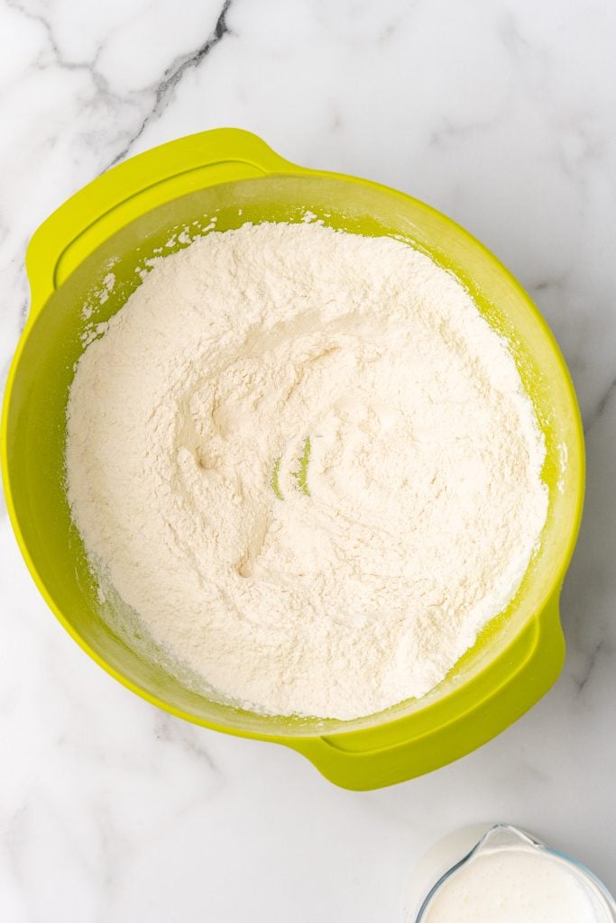flour in a large green mixing bowl