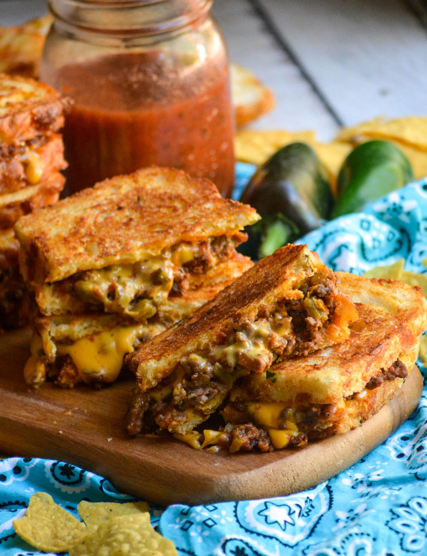 cut tex mex grilled cheese sandwiches arranged on a wooden cutting board