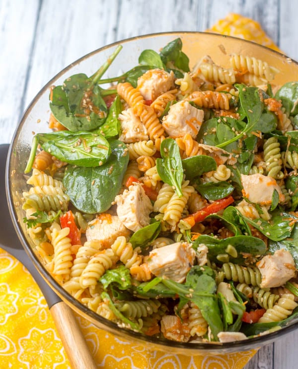 Asian Style Chicken Spinach Pasta Salad in a glass bowl