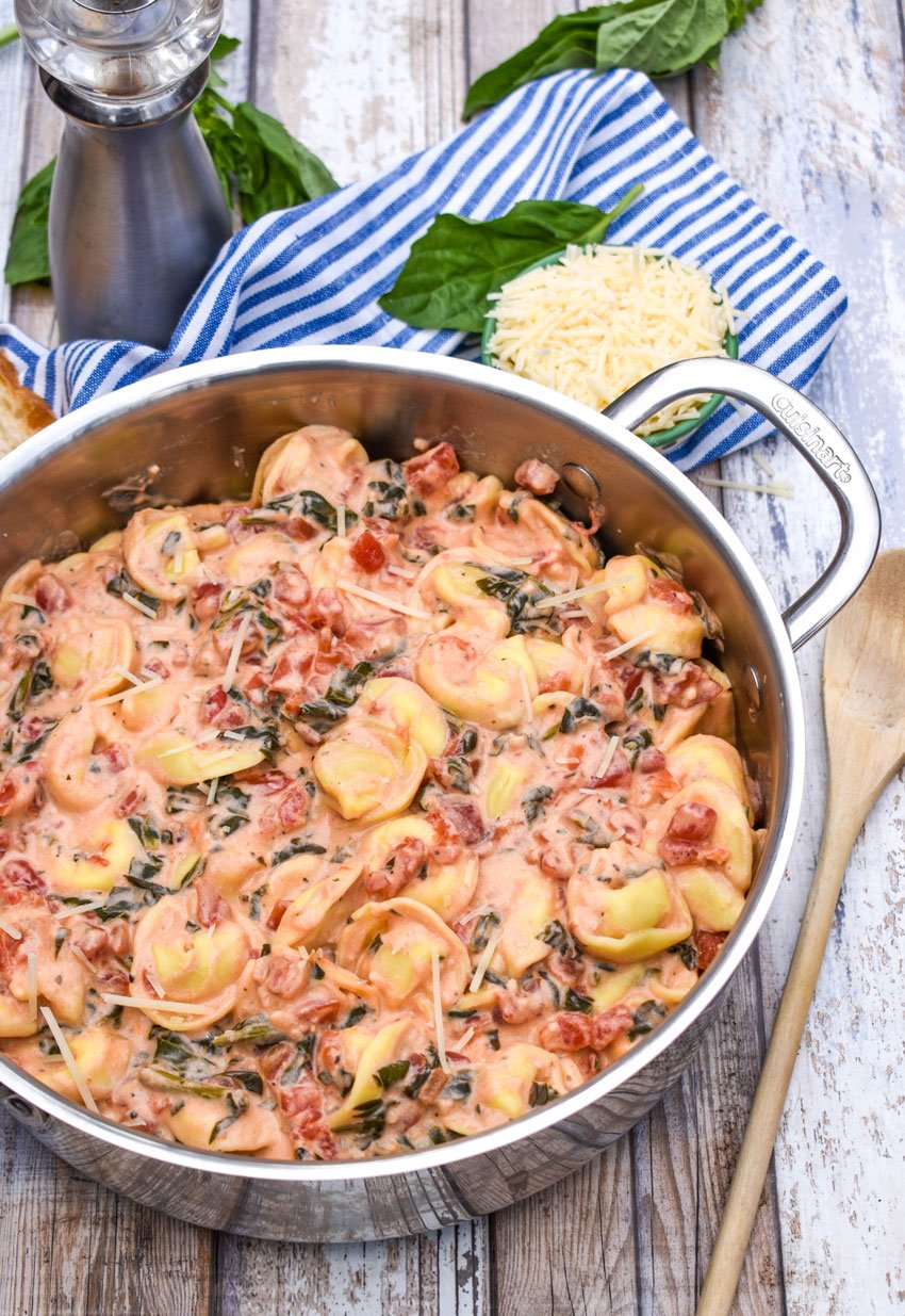 Creamy Tortellini with Spinach & Tomatoes in a silver skillet
