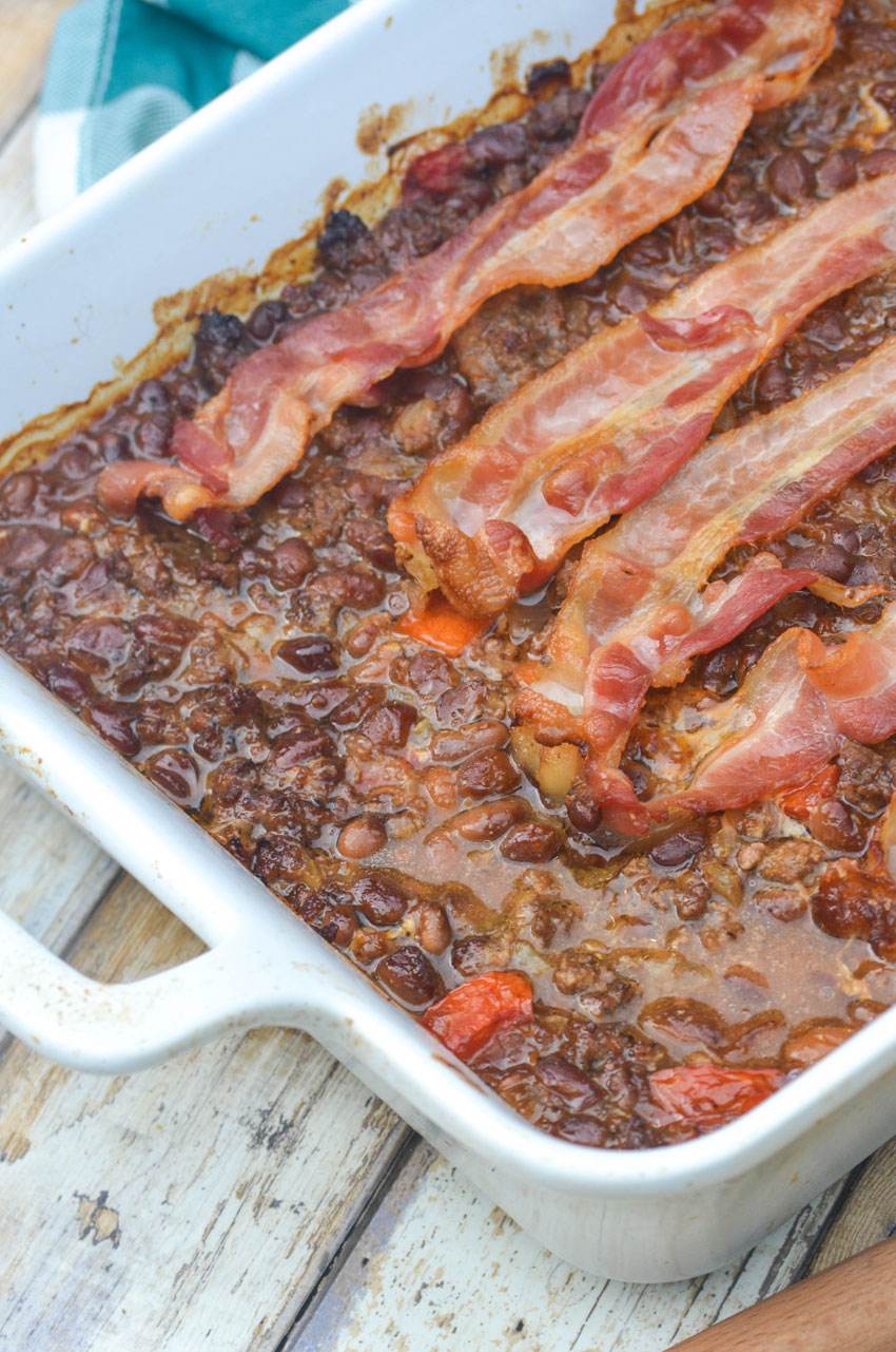 ground beef and baked bean casserole in a white baking dish